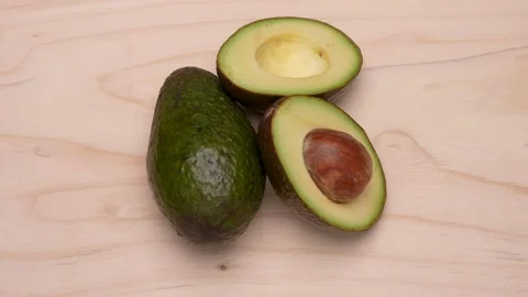 Half an avocado and one avocado. Stock Footage 305828946