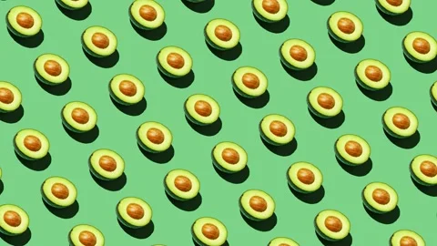Half avocado food pattern on green background Stock Footage 169173666