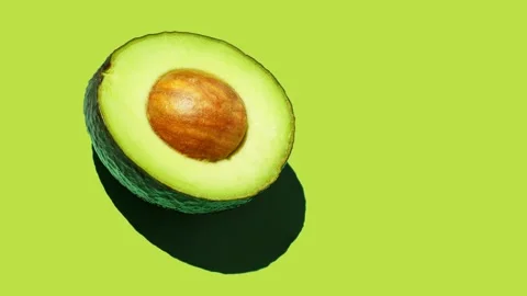 Half avocado food pattern on green background Stock Footage 169239219