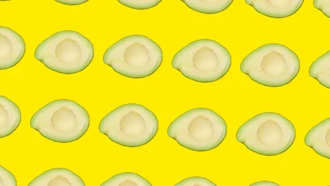 A half of Avocado in seamless loop pattern on a yellow background. Exotic fruits Stock Footage 222327138