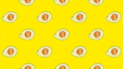 A half of Avocado with seed in seamless loop pattern on a yellow background Stock Footage 222319165