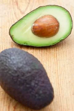 Half an avocado with stone Stock Photos