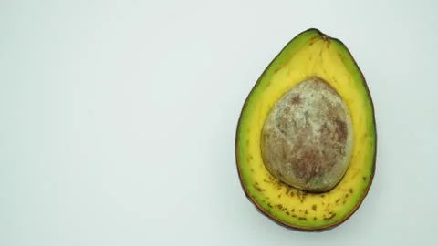 Half Avocado on white background. Stock Photos