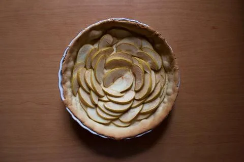 Half baked pie filled with sliced apples Stock Photos