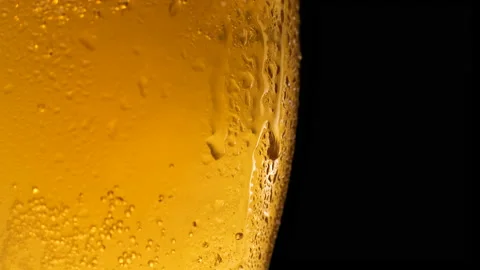 Half a beer glass with falling water drops. Cold beer in a glass  Stock Footage 153274635