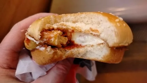 Half-bitten chicken burger bought in the city. Video stock 310854868