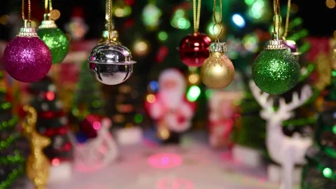 On a half-blurred Christmas background, small Christmas decorations swing slowly Stock Footage 255912750