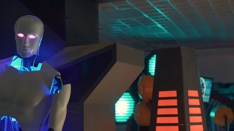 Half of the body of the robot moves without one hand. The eyes of the robot glow Stock Footage 98865739