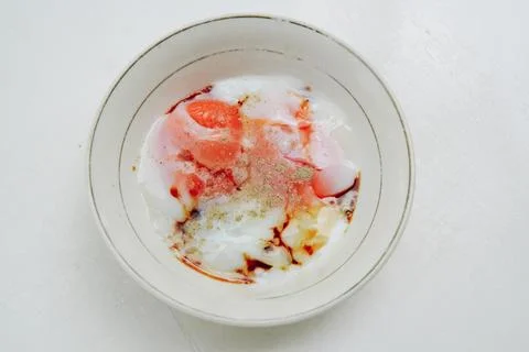 Half-boiled egg dish served in a white bowl. Concept for healthy food, omeg.. Foto stock