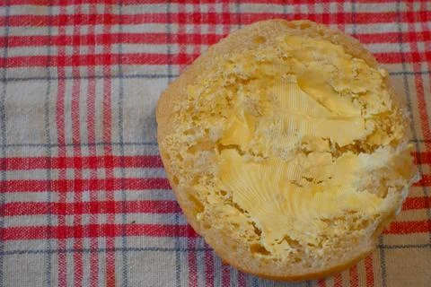 Half bread roll with margarine Fotos de archivo