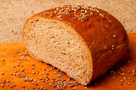Half of bread on wooden table Stock Photos