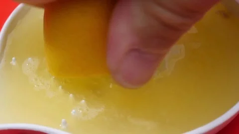 Half of bright ripe lemon is pressed on and fresh juice flows down. Healthy.. Stock Footage 265839506