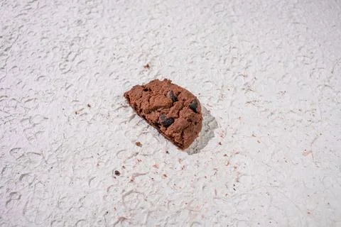 A Half Of Broken Cookie Set On A White Surface To Highlight Its Crisp Edges. Stock Photos