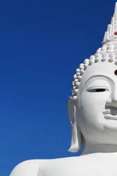 Half of a buddha's face in a dramatic sky background Stock Photos