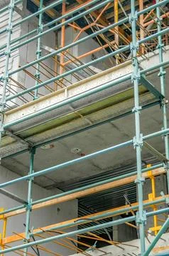 A half-built structure with scaffolding and visible concrete floors Stock Photos