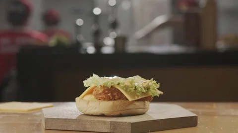 Half Bun falls on chicken burger in slow motion Stock Footage 120082142