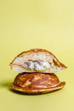 Half of burger with no top bread isolated on pastel yellow background Stock Photos