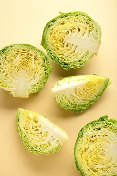 Half of cabbage on a beige background. Vertical photo Stock Photos