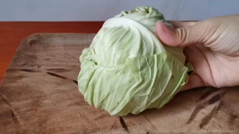 Half Cabbage on a Chopping Board Stock Footage 158076336