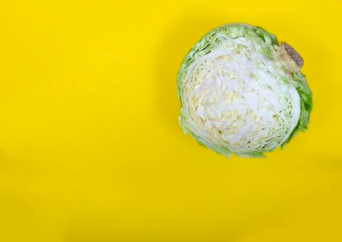 Half a cabbage on yellow backround Stock Photos