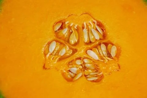 Half a cantaloup sitting on the kitchen table waiting to be eaten Stock Photos