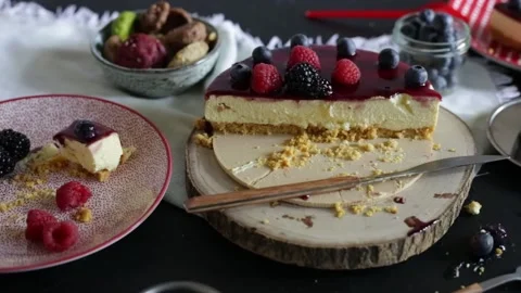 Half cheesecake with raspberry and blueberries on wooden table. Dessert time. Stock Footage 131715464
