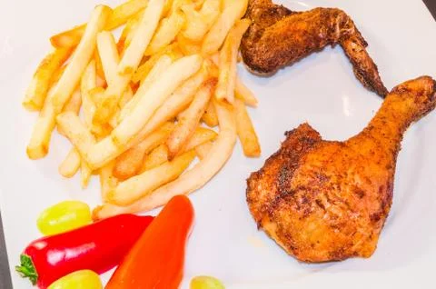 Half a chicken with chips Stock Photos