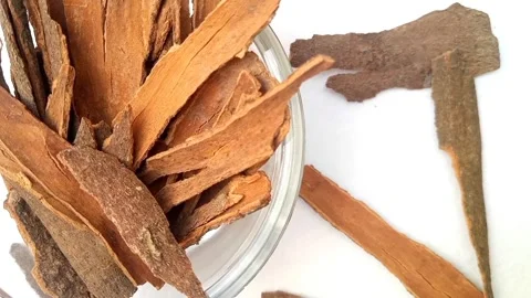Half of circle shaped Cinnamon sticks glass bowl spices spilled around it Stock Footage 275571942