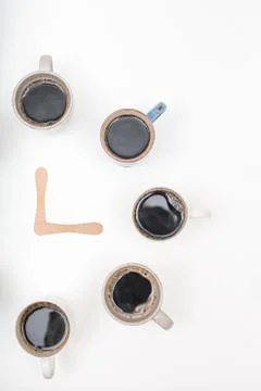 Half Clock made of  cups of coffee on white background with copy space Stock Photos