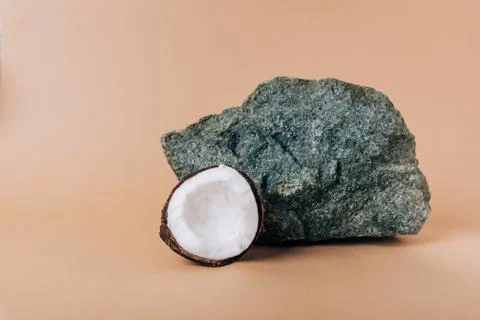 Half a coconut on a stone background close-up Stock Photos