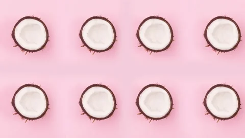 Half coconuts rotating on pink theme. Stop motion Stock Footage 148767944