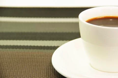 Half coffee on pattern napery Stock Photos