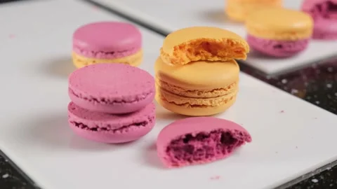 Half of the cream-free macarons, arranged on a white plate. Stock Footage 148659938
