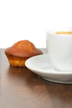 Half cup of coffee with cupcake on table Stock Photos