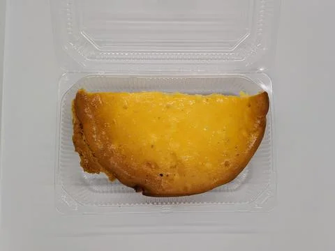 Half a curd pie. half of curd cake in a plastic container on a white backgrou Fotos Stock