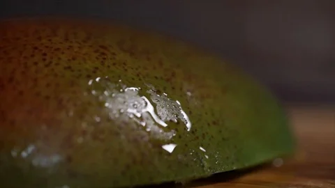 Half Cut Mango Drop of Water Runs Down Extreme Closeup Stock Footage 99163798