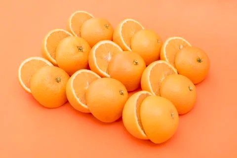 Half-cut oranges on orange background Stock Photos