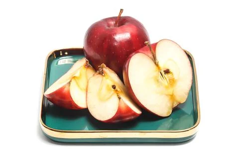 Half cut sliced and two whole fresh organic red apple delicious fruit in a .. Stock Photos