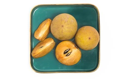 Half cut sliced and two whole fresh organic sapodilla delicious fruit top v.. Stock Photos