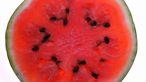 Half of delicious ripe watermelon rotates on white background in 4K 動画素材 87068898