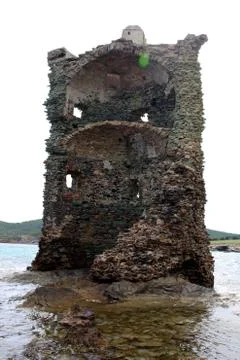 Half destroyed tower showing inside standing over the sea Stock Photos