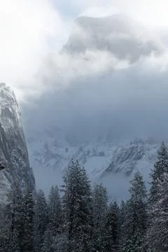 Half Dome with snow and clouds Stock Photos