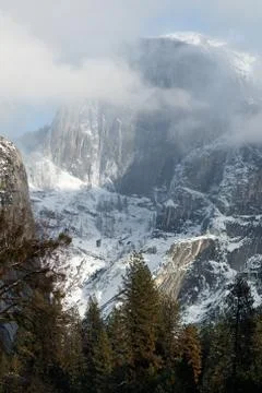 Half Dome with snow and clouds Stock Photos