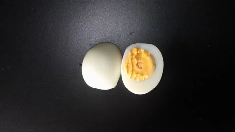 Half of egg on black background top view 스톡 동영상 167338715
