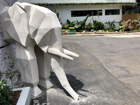 Half elephant statue decoration with diamond pattern design on the wall Foto stock