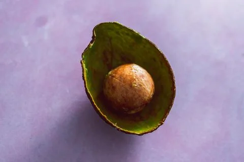 Half empty avocado with pulp removed and only pip and skin remaining Stock Photos