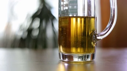 Half empty beer mug on table Stock Footage 77570758