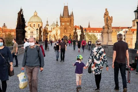 Half-empty Charles Bridge in Prague during the coronavirus pandemic, with peo Stock Photos