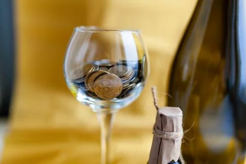 Half empty, half full transparent drinking glass with coins 스톡 사진