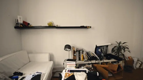 A half-empty living room, with few furniture and objects out of place, Stock Footage 101746020